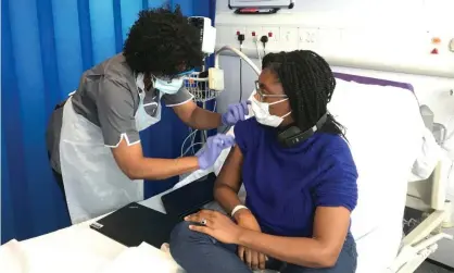  ??  ?? Kemi Badenoch, the UK’s minister for equalities, receiving her first vaccinatio­n as part of the Novavax phase 3 trial in October. Last week research showed that up to 72% of black people said they were unlikely or very unlikely to have an anti-Covid jab. Photograph: PA