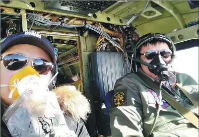  ?? PHOTO PROVIDED TO CHINA DAILY ?? Zhang Xinyu (right) pilots a Y-12 aircraft across the Atlantic Ocean from Fortaleza, Brazil, to Playa, Cape Verde, along with Liang Hong, his wife. They wear oxygen masks to deal with altitude sickness.