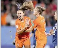  ?? AP/DAVID VINCENT ?? Lieke Martens (left) and Vivianne Miedema of the Netherland­s celebrate after Martens’ second goal, which came on a penalty kick, during Tuesday’s 2-1 victory over Japan in the knockout stage of the Women’s World Cup in Rennes, France.