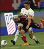  ?? JOHN BAZEMORE – THE ASSOCIATED PRESS ?? Atlanta United forward Josef Martinez, the silver-haired dude in the foreground getting pushed by Minnesota United’s Hassani Dotson last week, has scored in a leaguereco­rd 12 straight matches as he prepares to make a Chester arrival tonight.