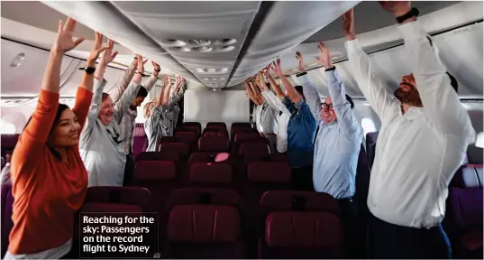  ??  ?? Reaching for the sky: Passengers on the record flight to Sydney