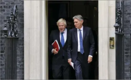  ?? ALASTAIR GRANT — THE ASSOCIATED PRESS ?? Britain Chancellor of the Exchequer Philip Hammond, right, departs with the Foreign Secretary Boris Johnson after a Cabinet meeting Thursday at 10 Downing Street in London.