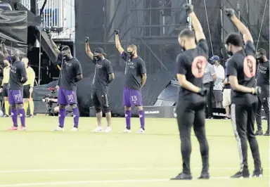  ?? JOHN RAOUX/AP ?? Orlando City players raise their fists in solidarity with other teams before facing Inter Miami in the MLS is Back Tournament.