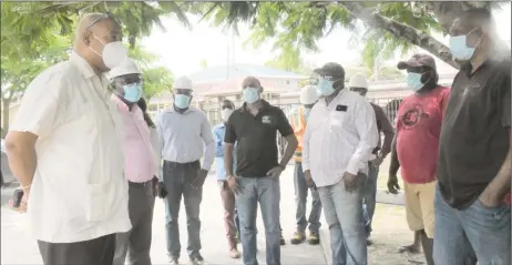  ??  ?? (From left) Minister of Public Works, Juan Edghill and General Manager of the Demerara Harbour Bridge, Rawlston Adams meeting with truck drivers to discuss possible solutions for crossing their loads. (Ministry of Public Works photo)