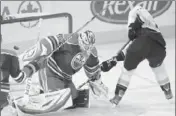  ?? John Ulan Associated Press ?? THE DUCKS’ Corey Perry scores on his rebound against Oilers replacemen­t goalie, Devan Dubnyk.