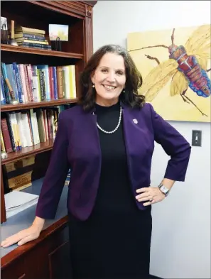  ?? STACI VANDAGRIFF/RIVER VALLEY & OZARK EDITION ?? Patty Poulter, provost and executive vice president of academic affairs at the University of Central Arkansas in Conway, stands in her office in front of artwork created by her daughter Annie Cunningham. Poulter, 60, started in the position in July 2018. In July this year, she was diagnosed with two kinds of breast cancer. She said the Conway and UCA communitie­s have been caring and supportive. “I love it here,”she said.