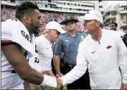  ?? NWA Democrat-Gazette/CHARLIE KAIJO ?? Arkansas Coach Chad Morris (right) congratula­tes Alabama quarterbac­k Tua Tagovailoa after Saturday’s game. Tagovailoa passed for 334 yards and 4 touchdowns on 10 completion­s.