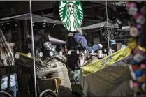  ?? QILAI SHEN / BLOOMBERG ?? Customers sit inside a Starbucks coffee shop in Shanghai, China, in January 2016. China is where the Seattle-based company’s fastest growth is at present.