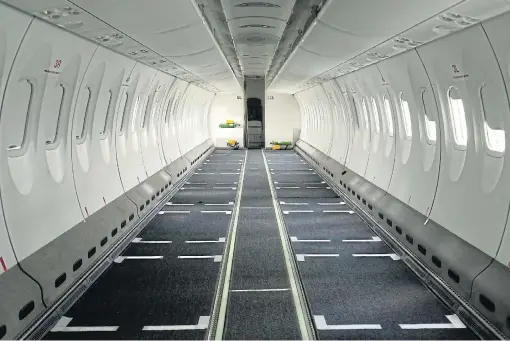  ?? /Reuters ?? Change in the air: An Ethiopian Airlines passenger carrier is seen without seats as it is converted into a cargo plane at Bole internatio­nal airport in Addis Ababa, Ethiopia, on May 15 2020. This quick pivot is expected to save the airline from potential financial ruin.