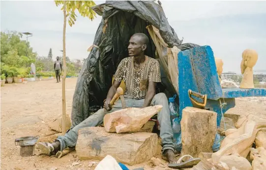  ?? CARMEN ABD ALI/THE NEW YORK TIMES PHOTOS ?? Malaw Sow, a sculptor, works on his pieces May 27 in Dakar, Senegal. The arts have descended on the capital for its first pandemic-era biennale.