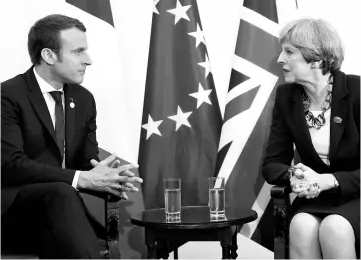  ??  ?? May and Macron talk during a bilateral meeting at the G7 Summit in Taormina, Sicily, Italy. — Reuters photo