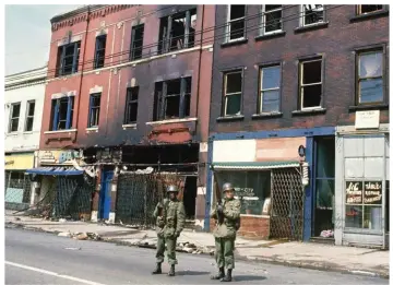  ??  ?? National Guardsmen patrol the streets of Chicago on April 6, 1968, following the riots and violence that ensued after the assassinat­ion of Martin Luther King Jr.