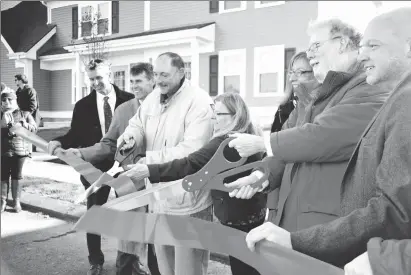  ?? Submitted photo ?? Officials cut the ceremonial ribbon on Greenridge Commons Saturday. Pictured from left: Michael Comiskey, vice president for community developmen­t, Citizens Bank; Rhode Isand Market President Bill Hatfield of Bank of America; Town Manager Michael C. Wood of Burrillvil­le; Dori Conlon, vice president of Bank of America; Barbara Fields, executive director, Rhode Island Housing; Joe Garlick, executive director, NeighborWo­rks Blackstone River Valley; Mike Tondra, chief of housing and community developmen­t, Rhode Island Office of Housing and Community Developmen­t.