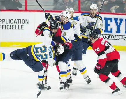  ?? THE CANADIAN PRESS ?? Senators centre Gabriel Dumont, left, and defenceman Mark Borowiecki chase Chris Thorburn of the St. Louis Blues as he’s protected by teammates Thursday night in Ottawa. Borowiecki and Dumont took exception to a hit by Thorburn on Filip Chlapik