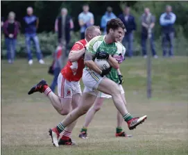  ??  ?? Kilmac’s Michael Masterson drives through as Tinahely’s Tony Darcy tries to put a stop to his gallop during the IFC clash in Ashford. Photo: Barbara Flynn