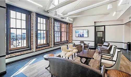  ?? [PHOTOS BY SIMON HURST PHOTOGRAPH­Y] ?? Rooms in the renovated Old North building on the University of Central Oklahoma campus feature exposed stone, re-purposed flooring and other elements that pay homage to the original constructi­on.