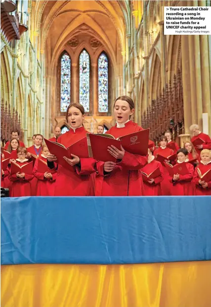  ?? Hugh Hastings/Getty Images ?? > Truro Cathedral Choir recording a song in Ukrainian on Monday to raise funds for a UNICEF charity appeal