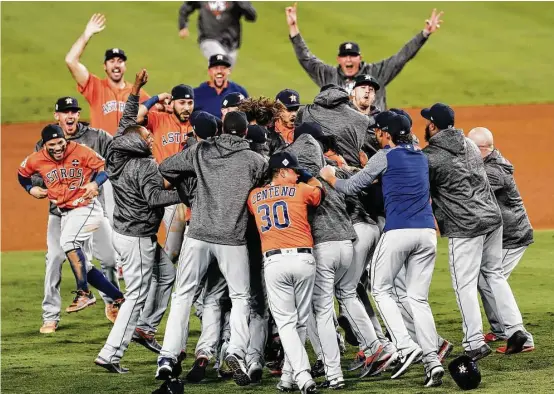  ?? Brett Coomer / Houston Chronicle ?? Jubilant Astros players started a 55-years-in-the-making celebratio­n after claiming their first World Series title with the traditiona­l pile-up near the pitcher’s mound.