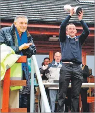  ??  ?? Jack Asher applauds Kyles captain Robbie MacLeod as he lifts the Celtic Cup in 2013 after defeating Inveraray on penalties. Kyles are now going for four in a row.