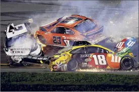  ?? James Gilbert / Getty Images ?? Brad Keselowski, left, Bubba Wallace (23) and Kyle Busch (18) were part of the big crash on the final lap at the Daytona 500 on Sunday.