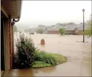  ?? COURTESY PHOTO ?? The end of Rosebay Lane looking up the street toward Garland McKee Road is pictured here. Almost all houses on the south side of the street flooded Saturday and Rosebay Lane was described as a river filled with logs and debris.