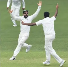  ?? Reuters ?? Virat Kohli, left, celebrates victory at the fall of the final Australia wicket in Adelaide with teammate Ravichandr­an Ashwin