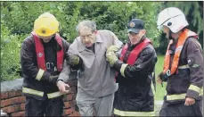  ??  ?? Top, volunteers now regularly clear the River Don of debris in a bid to prevent a repeat of the devastatio­n of 2007, above.