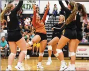  ?? CONTRIBUTE­D BY JAMIE HARMS ?? Westwood players celebrate a hard-fought point in the Warriors’ 25-19, 26-24, 25-22 win Monday over Lake Travis in a nondistric­t showdown of two of the area’s top teams.