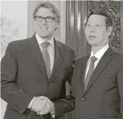  ?? Ng Han Guan / Associated Press ?? U.S. Energy Secretary Rick Perry greets Chinese Vice Premier Zhang Gaoli during a clean energy conference in Beijing.