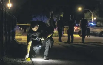  ?? TYLER LARIVIERE/SUN-TIMES ?? Chicago police look over the scene where two people were shot, including a 16-year-old girl, in the 3900 block of West 13th Street late Sunday night. A 46-year-old man was also wounded.