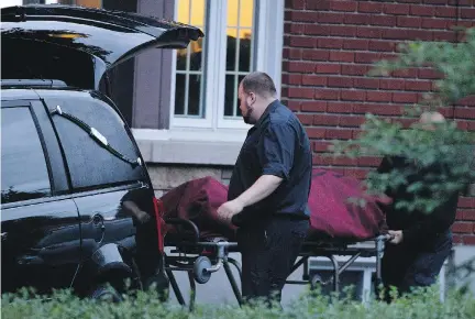  ?? ALLEN McINNIS/MONTREAL GAZETTE ?? A body is loaded into a morgue truck from a Beloeil home where Cheryl Bau-Tremblay was found dead.