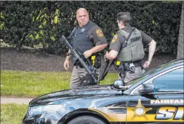  ?? Alex Brandon The Associated Press ?? Fairfax Sheriff ’s deputies arrive near the building that houses Gannett and USA Today on Wednesday in Mclean, Va. The building was evacuated for several hours.