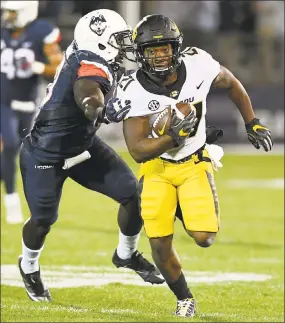  ?? Jessica Hill / Associated Press ?? UConn linebacker Junior Joseph, left, pursues Missouri running back Ish Witter in a game on Oct. 28 in East Hartford.