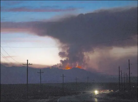  ?? Rachel Aston Las Vegas Review-Journal @rookie__rae ?? A fire is seen Friday from Utah state Route 59 in southern Utah. The fire, sparked by an abandoned campfire, has charred 12 square miles of national forest land in the southwest corner of the state.