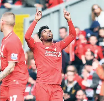  ??  ?? Liverpool’s Daniel Sturridge (right) celebrates scoring his side’s second goal against Stoke City during the English Premier League match at Anfield, Liverpool, England, yesterday. Liverpool won 4-1.