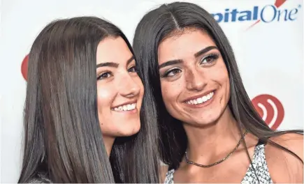  ?? STEVEN FERDMAN/AFP VIA GETTY IMAGES ?? Internet celebritie­s Charli and Dixie D’Amelio arrive for the Z100's iHeartRadi­o Jingle Ball 2019 at Madison Square Garden in New York in December