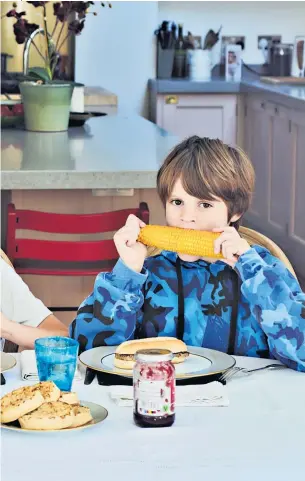  ?? ?? Tuck in: Lucy Denyon and her three boys make a meal of it on Wednesday