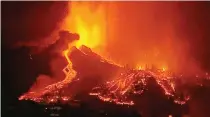  ?? FORTA/HANDOUT VIA REUTERS ?? LAVA POURS OUT of a volcano in the Cumbre Vieja national park at El Paso, on the Canary Island of La Palma, Sept. 19, in this screen grab taken from a video.
