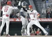  ?? John McCoy Getty Images ?? ANDRELTON SIMMONS is met by Shohei Ohtani in front of catcher Robinson Chirinos after his homer.