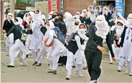  ?? — PTI ?? Girl students pelt stones at security personnel during clashes in the vicinity of Lal Chowk in Srinagar on Monday.