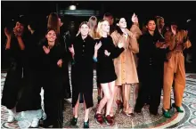  ??  ?? Models dance and sing at the end of the StellaMcCa­rtney women’s Fall-Winter 2017-2018 ready-to-wear collection fashion show in Paris.