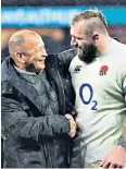  ??  ?? Good work: Eddie Jones (left) and Joe Marler celebrate their runaway win