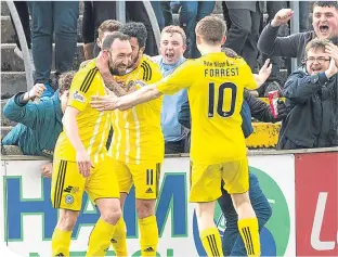  ??  ?? Ayr’s Michael Moffat (left) celebrates after opening the scoring