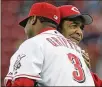  ?? AL BEHRMAN / AP 2007 ?? Cincinnati Reds outfielder Ken Griffey Jr. hugs former Red Chuck Harmon after he threw out the ceremonial first pitch in a 2007 game.