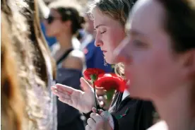  ?? Photograph: Joshua L Jones/AP ?? People mourn the death of Laken Riley at the University of Georgia, Athens, on 26 February 2024.