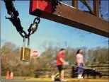  ?? DAVID GOLDMAN / AP ?? A padlock hangs from the locked gates to the Kennesaw Mountain National Battlefiel­d Park visitor center in Kennesaw, Ga., on Sunday.