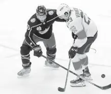  ?? PAUL VERNON/AP ?? Florida Panthers forward Carter Verhaeghe, right, works for the puck against Columbus Blue Jackets defenseman Michael Del Zotto.