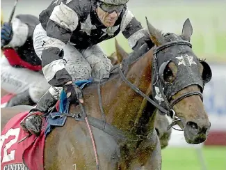  ?? PHOTO: DAVID HALLETT/STUFF ?? Mike wins the 2002 New Zealand Cup ridden by Noel Harris and trained by Ray Harris.