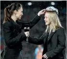  ??  ?? Kendra Cocksedge receives her 50th test cap from New Zealand Prime Minister Jacinda Ardern.