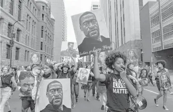  ?? AARON NESHEIM/THE NEW YORK TIMES ?? Demonstrat­ors march through Minneapoli­s on June 25, after Derek Chauvin’s sentencing for killing George Floyd by kneeling on his neck. Police initially said Floyd’s death was the result of a “medical incident.”